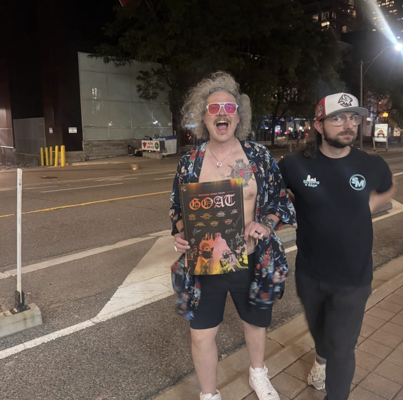 Andrew holding the signed Goat Canada 2026 tour poster after the show